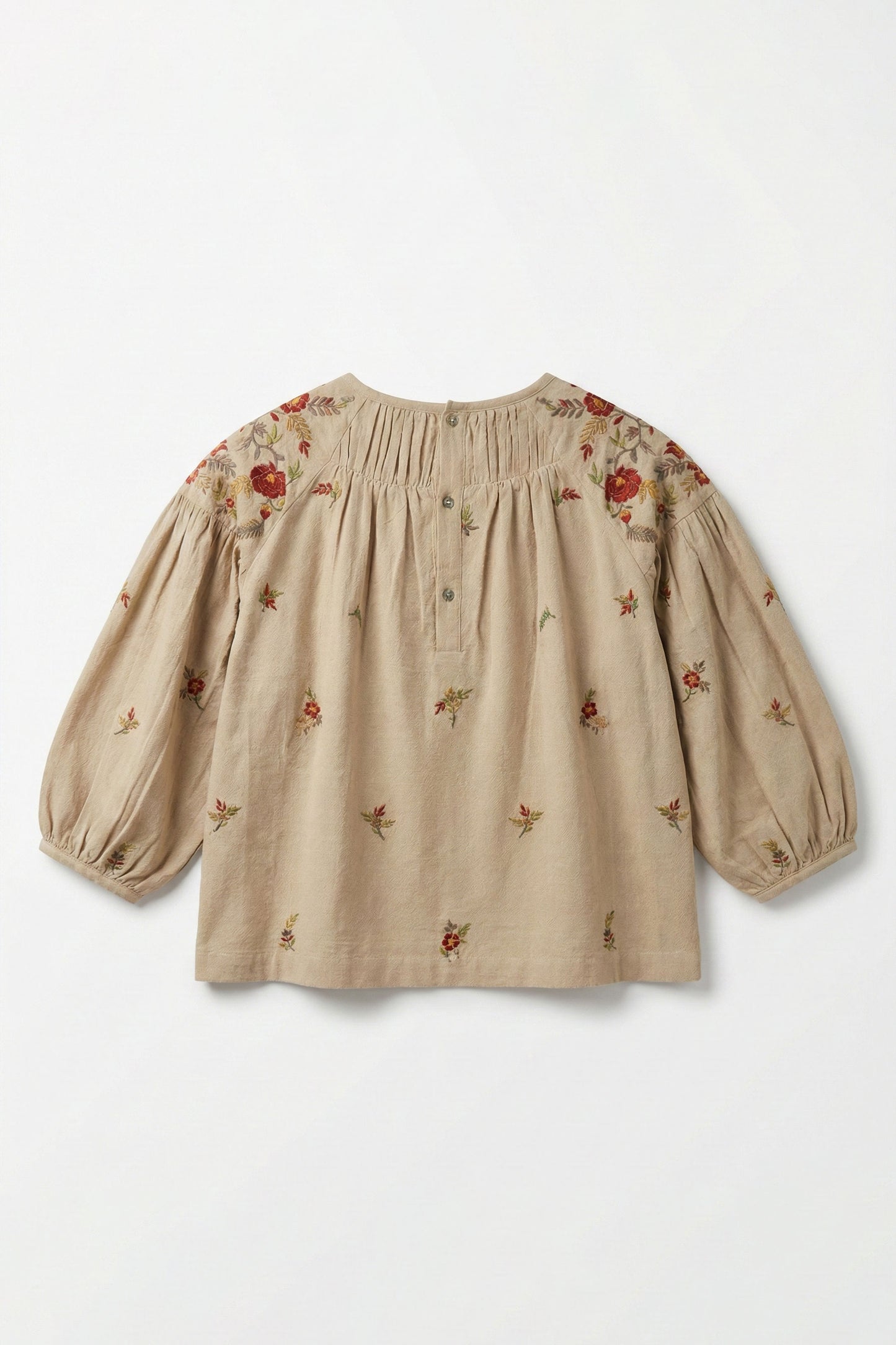 Beige blouse with floral embroidery on a white background