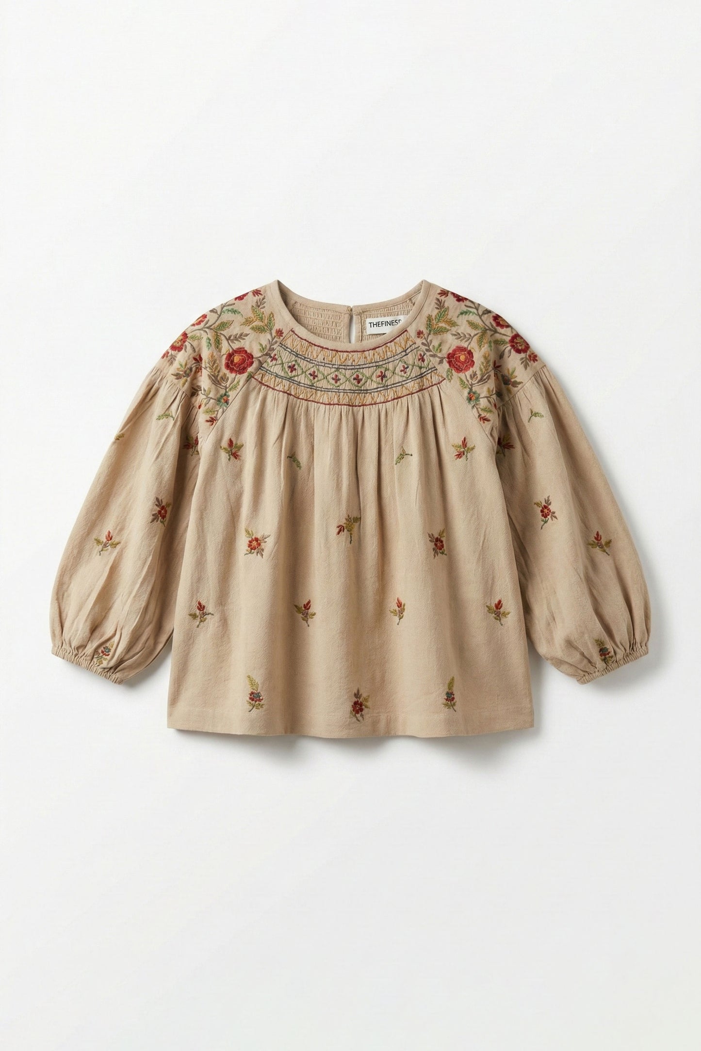 Beige blouse with floral embroidery on a white background