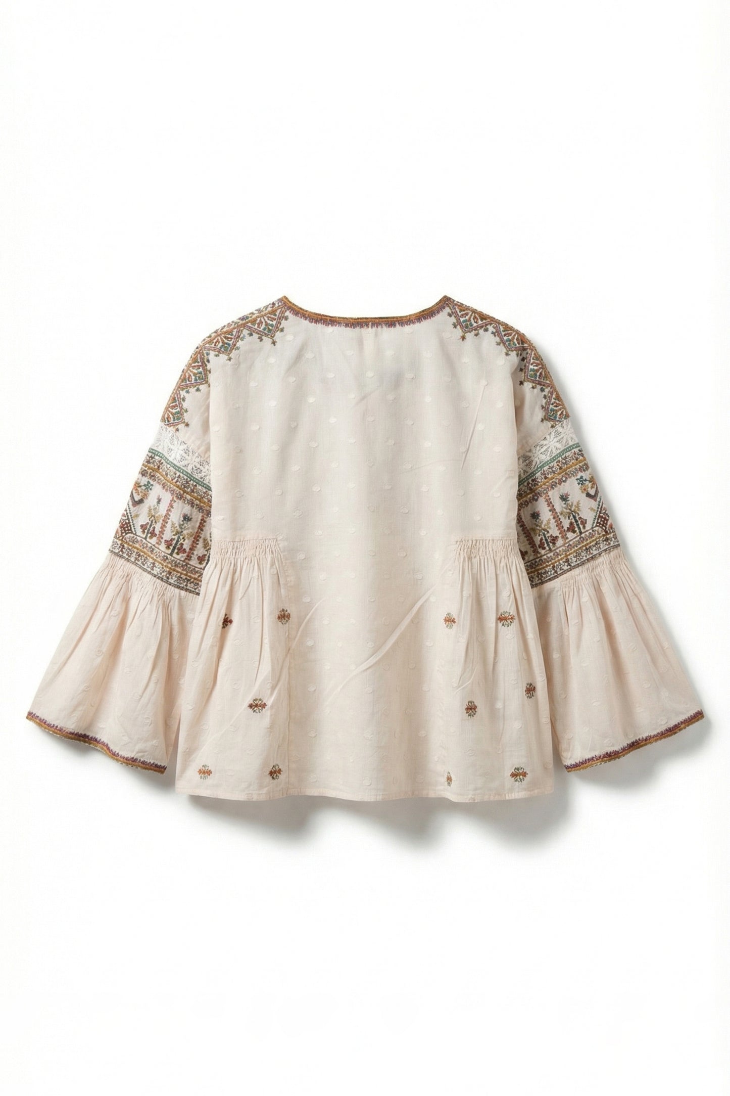 Beige blouse with intricate embroidery on a white background