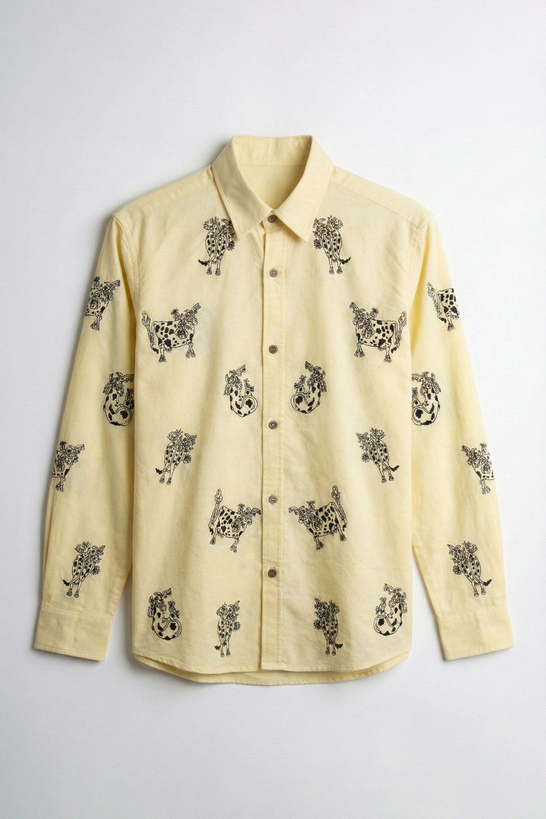 Yellow shirt with black pattern on a light gray background