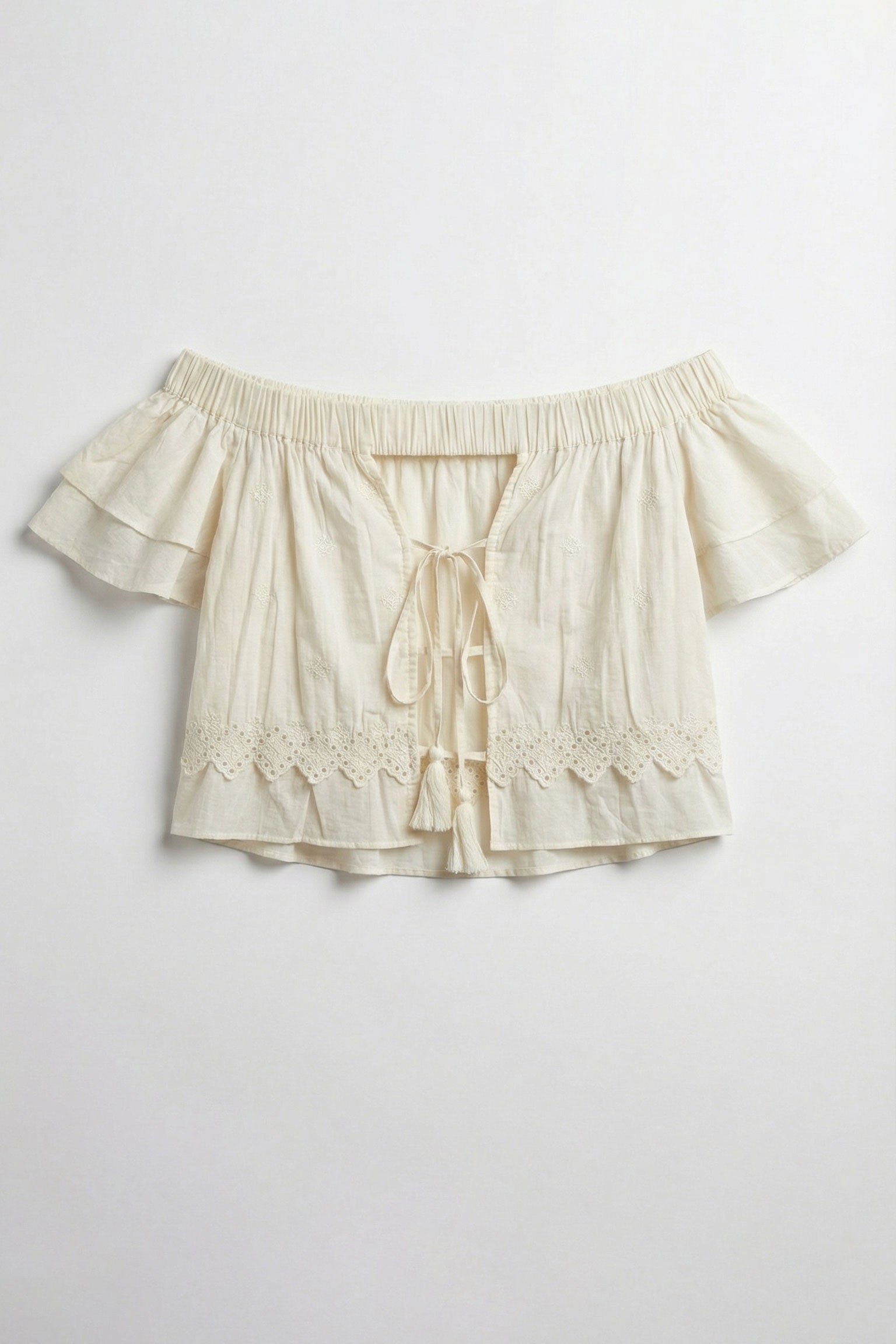 Beige shorts with ruffled details on a light gray background