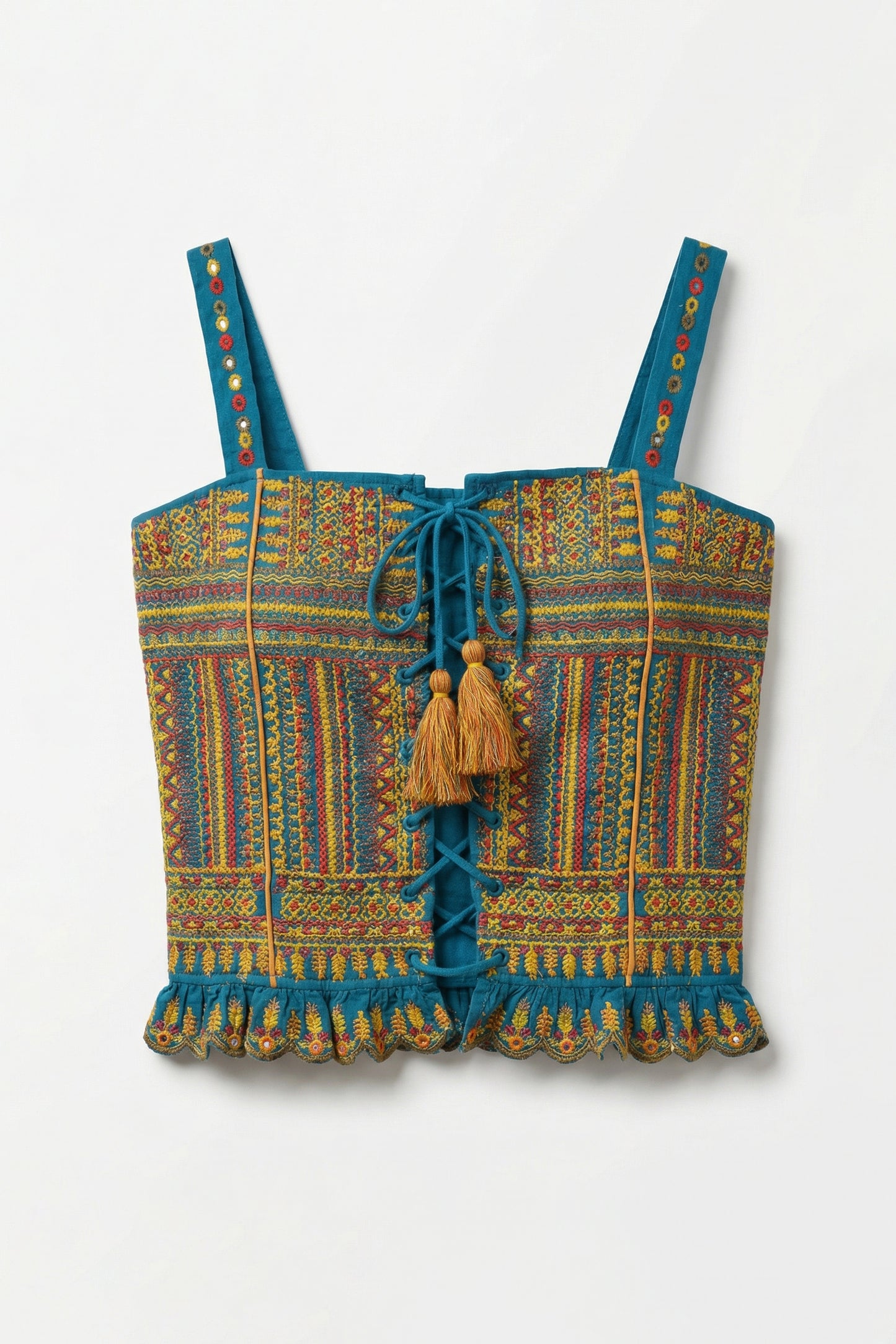 Colorful patterned top with tassels on a white background