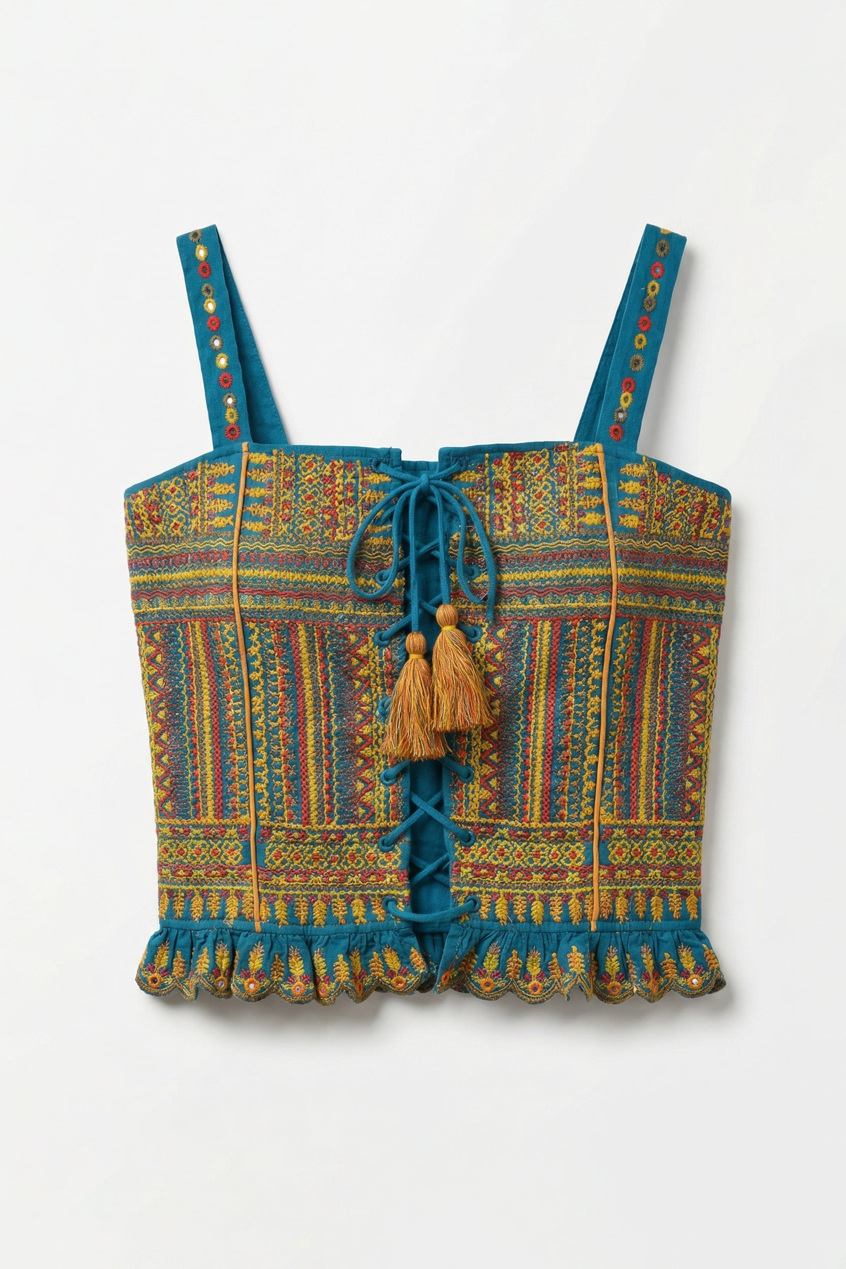 Colorful patterned top with tassels on a white background